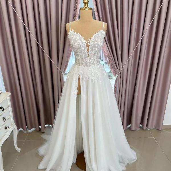 a line wedding dresses with slit for bride 2025, spaghetti straps bridal dresses, lace appliques wedding gowns 2024, deep v neck tulle bridal gowns, a line bridal gowns, tulle wedding dresses with lace appliques
